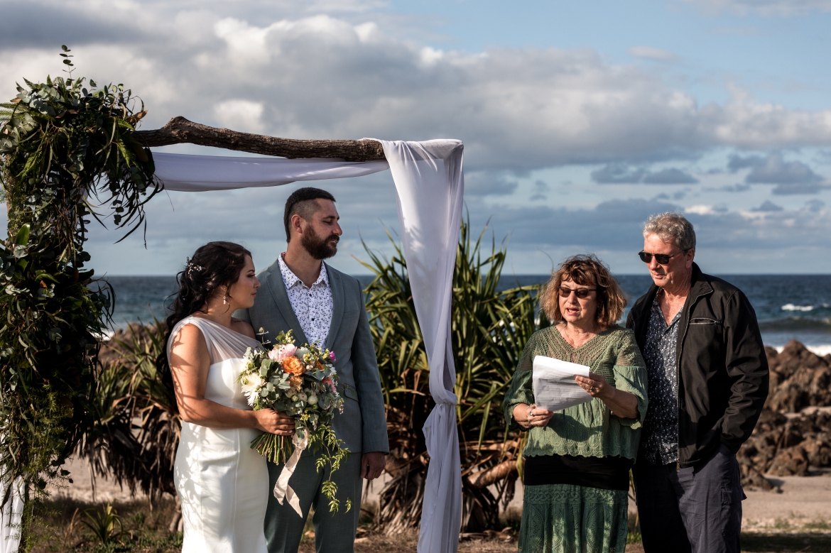 groom parents reading at elopement ceremony  at cabrita beach nsw