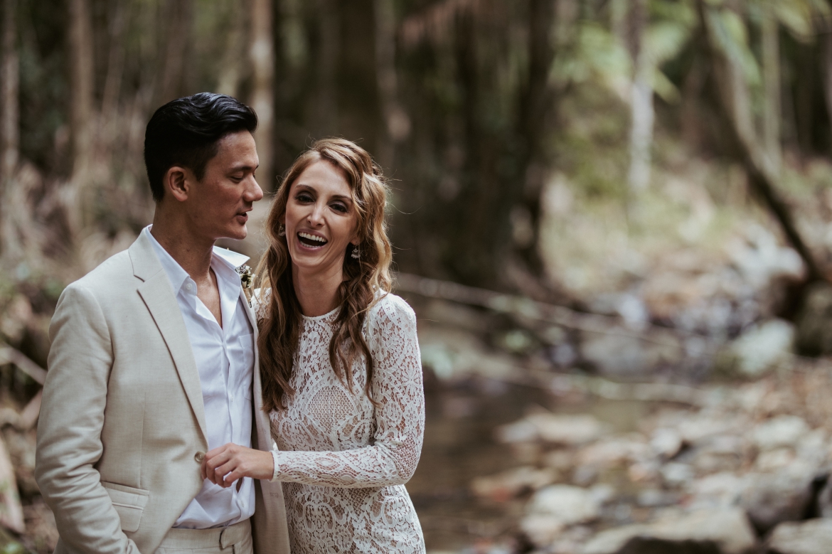 A fun moment after the ceremony as the couple share a laugh by the creek side at crystal creek rainforest retreat. CCRR