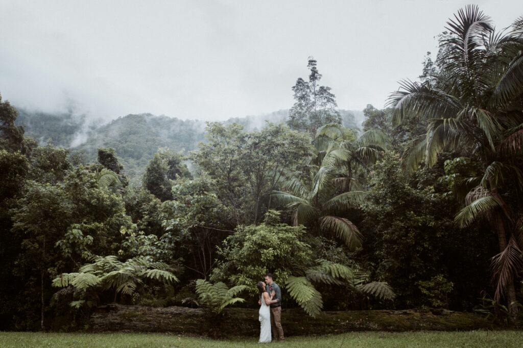 The newly wed couple standing in front of the majestic mountain views at their accommodation springbrook mountain view lodge at Crystal creek rainforest retreat, NSW. CCRR