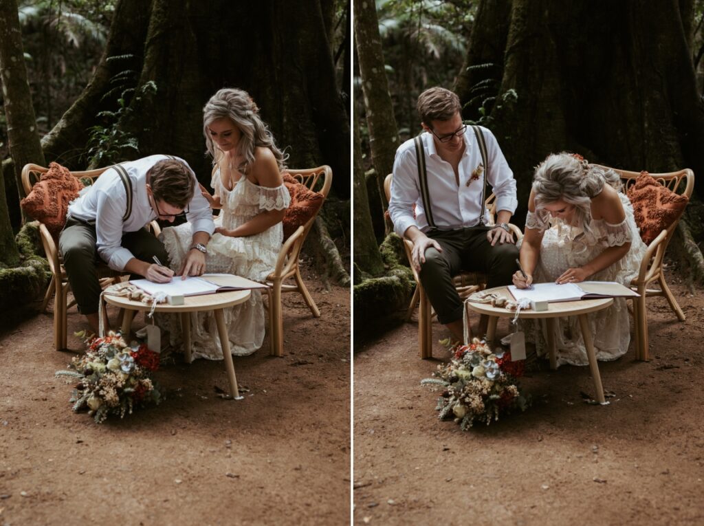 The couple sign the marriage certificate beneath the fig tree, seated on rattan seating set at crystal creek rainforest retreat. CCRR
