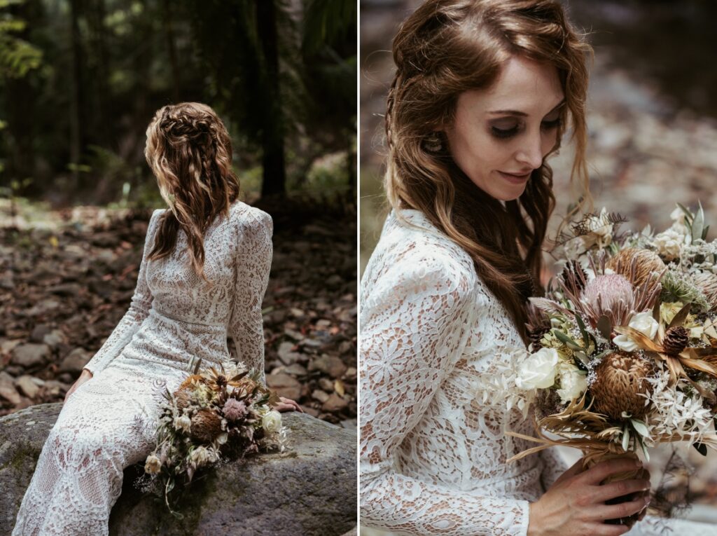 Beautiful portraits of the bride sitting on a boulder in the creek at crystal creek rainforest retreat while holding her bouquet.