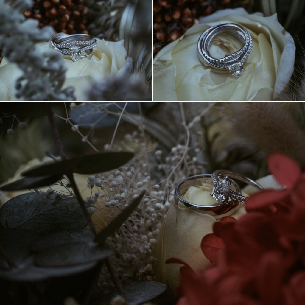 Close up of wedding rings on a creamy white rose among the brides bouquet.