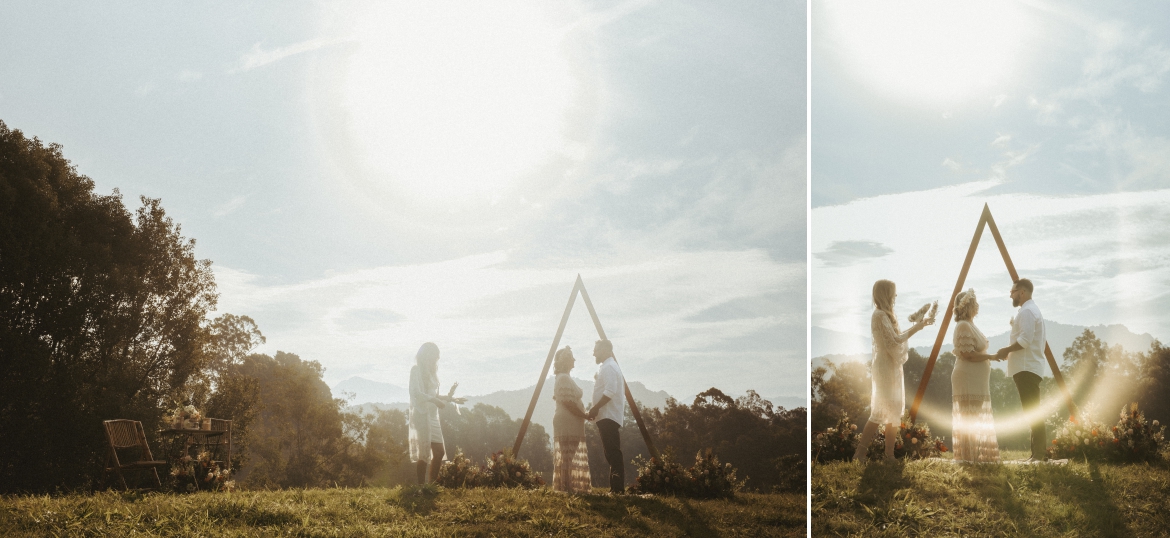 Bride wearing a Jaase dress and groom with their celebrant in front of a triangle arbour late afternoon hill top elopement at Bunyarra in Crystal Creek NSW